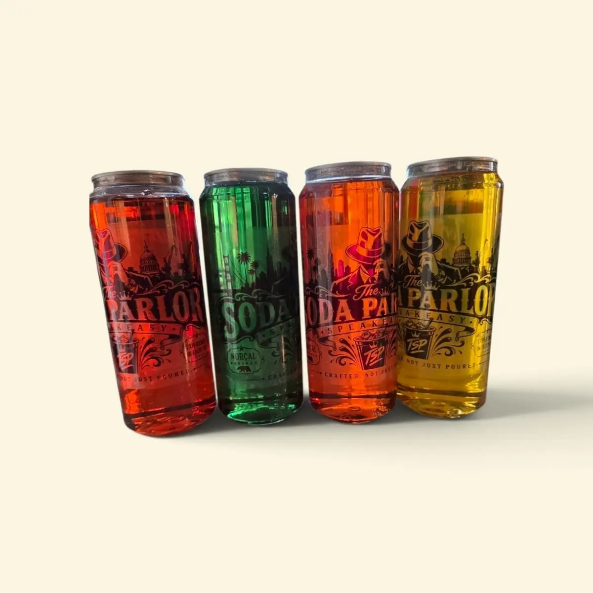 Four colorful custom canned drinks from The Soda Parlor Speakeasy